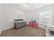 Bedroom with a crib, pink storage drawers, and a changing table near a window at 9652 Spencer Woods Rd, Ladson, SC 29456