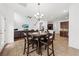 Open dining area with a wooden table set, seamlessly blending with the living space and kitchen at 9652 Spencer Woods Rd, Ladson, SC 29456