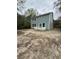 Backyard view of a two-story home featuring a private patio and ample space for outdoor activities at 971 Beehive Rd, Awendaw, SC 29429