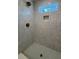 Modern shower with neutral tile, a built-in niche, stylish fixtures, and a glass enclosure at 971 Beehive Rd, Awendaw, SC 29429