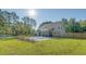 Large backyard featuring an in-ground pool, patio, well-manicured lawn and bordering fence at 1010 Deep Gap Rd, Ridgeville, SC 29472