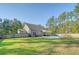 Large fenced backyard featuring an in-ground pool, patio, and lush lawn with mature trees at 1010 Deep Gap Rd, Ridgeville, SC 29472
