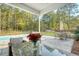 Outdoor patio area with comfortable seating, a dining table, grill, and a refreshing swimming pool at 1010 Deep Gap Rd, Ridgeville, SC 29472
