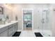 Bright bathroom with a glass shower, gray cabinets, and a modern vanity at 1010 Deep Gap Rd, Ridgeville, SC 29472
