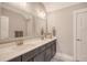 Bathroom featuring double sinks, modern fixtures, and a decorative sign, creating a cozy and inviting space at 1010 Deep Gap Rd, Ridgeville, SC 29472