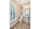Bright half bathroom featuring a pedestal sink, toilet, and a window with blinds at 1010 Deep Gap Rd, Ridgeville, SC 29472