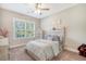 Charming bedroom featuring neutral walls, carpet, a ceiling fan, bright windows, and a comfortable bed with storage at 1010 Deep Gap Rd, Ridgeville, SC 29472