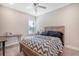 Inviting bedroom with neutral walls, carpet, and a ceiling fan, along with a bright window and wooden bed frame, creating a cozy retreat at 1010 Deep Gap Rd, Ridgeville, SC 29472