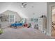 Bright bedroom boasts a ceiling fan, carpet, neutral walls, storage bed, and decor, creating a cozy atmosphere at 1010 Deep Gap Rd, Ridgeville, SC 29472
