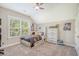 Comfortable bedroom featuring neutral walls, carpet, a ceiling fan, a bright window, and a wooden bed frame for a relaxed atmosphere at 1010 Deep Gap Rd, Ridgeville, SC 29472