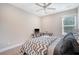 Cozy bedroom with neutral walls, carpet, and a ceiling fan, complemented by a bright window and wooden desk, creating a warm ambiance at 1010 Deep Gap Rd, Ridgeville, SC 29472