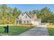 View of the home with fresh landscaping, attached garage and extended driveway at 1010 Deep Gap Rd, Ridgeville, SC 29472