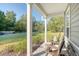 Cozy front porch featuring comfortable seating and a view of the neighborhood street at 1010 Deep Gap Rd, Ridgeville, SC 29472
