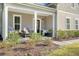 Inviting front porch with decorative chairs, plants, and a charming fall wreath on the door at 1010 Deep Gap Rd, Ridgeville, SC 29472