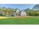 Charming two-story home with a spacious front yard, mature trees, and a well-maintained lawn at 1010 Deep Gap Rd, Ridgeville, SC 29472