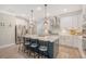 Open kitchen design featuring white cabinets, stainless steel appliances, and a large center island with seating at 1010 Deep Gap Rd, Ridgeville, SC 29472