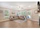 Bright living room boasts a comfortable sectional sofa, large windows, and access to the outdoor space at 1010 Deep Gap Rd, Ridgeville, SC 29472