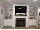 Beautiful fireplace with a large television, mantle, shelving, storage, and shiplap in the living room at 1010 Deep Gap Rd, Ridgeville, SC 29472