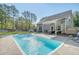 Outdoor pool featuring a water fountain, patio, and lounge seating in fenced backyard at 1010 Deep Gap Rd, Ridgeville, SC 29472