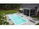 Aerial view of backyard pool with patio, furniture, and a meticulously landscaped lawn at 1010 Deep Gap Rd, Ridgeville, SC 29472