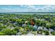 Scenic aerial view showcases a charming neighborhood nestled amidst lush greenery with a waterfront backdrop and an arrow showing the property at 1011 Ashley Ave, Charleston, SC 29403