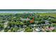 Aerial view showcases a quiet neighborhood with lush trees and a waterfront setting, an arrow pointing to the subject property at 1011 Ashley Ave, Charleston, SC 29403