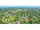 Aerial view of a tree-filled community with a bridge and city skyline, arrow pointing to the home's location at 1011 Ashley Ave, Charleston, SC 29403