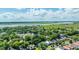 Expansive aerial view shows a vibrant community with tree-covered streets near a tranquil river and marshlands at 1011 Ashley Ave, Charleston, SC 29403