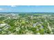This high aerial showcases houses, dense trees, urban infrastructure and the distant harbor and shipping facilities at 1011 Ashley Ave, Charleston, SC 29403