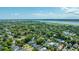 Expansive aerial view of a neighborhood with lush greenery, houses, and a waterfront in the background at 1011 Ashley Ave, Charleston, SC 29403