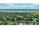 Aerial view of a residential area with charming homes surrounded by lush trees with the marshlands and river in the distance at 1011 Ashley Ave, Charleston, SC 29403
