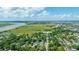 Picturesque aerial view showcasing a river, marshlands, and a neighborhood nestled among dense trees under a sunny sky at 1011 Ashley Ave, Charleston, SC 29403