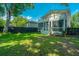 Spacious backyard showcasing lush greenery, a charming home, and a secure privacy fence at 1011 Ashley Ave, Charleston, SC 29403