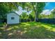 Well-kept backyard featuring a convenient storage shed, complemented by a dark fence and greenery at 1011 Ashley Ave, Charleston, SC 29403