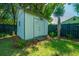 Storage shed in a grassy backyard, bordered by a dark fence and landscaping at 1011 Ashley Ave, Charleston, SC 29403