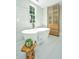 Elegant bathroom with soaking tub, marble floors and walls, and custom wood cabinet at 1011 Ashley Ave, Charleston, SC 29403