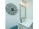 Well-lit bathroom featuring a modern vanity, decorative mirror, and stylish wall art, enhancing its appeal at 1011 Ashley Ave, Charleston, SC 29403