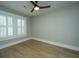 Bright, airy bedroom showcasing hardwood floors, white trim, and large windows for natural light at 1011 Ashley Ave, Charleston, SC 29403
