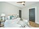 Comfortable bedroom features a ceiling fan, soft lighting, and decorative pillows and throw at 1011 Ashley Ave, Charleston, SC 29403
