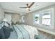 Bright bedroom with a ceiling fan, hardwood floors, and view of the home's entrance from the bed at 1011 Ashley Ave, Charleston, SC 29403