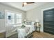 Cozy bedroom with soft lighting, a ceiling fan, and a comfortable bed with decorative pillows and throw at 1011 Ashley Ave, Charleston, SC 29403