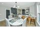 Stylish dining area with modern lighting, hardwood floors, and open access to the kitchen for convenient entertaining at 1011 Ashley Ave, Charleston, SC 29403