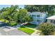 Attractive two-story house featuring a cozy front porch, well-manicured lawn, and beautiful blooming bushes at 1011 Ashley Ave, Charleston, SC 29403