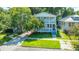 Charming two-story home featuring a inviting porch, manicured lawn, and blooming trees at 1011 Ashley Ave, Charleston, SC 29403