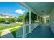 Inviting front porch with calming blue floors and ceiling offering a peek into the neighborhood at 1011 Ashley Ave, Charleston, SC 29403