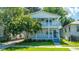 Charming two-story home with double porches and a landscaped front yard on a sunny day at 1011 Ashley Ave, Charleston, SC 29403