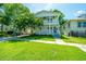 Charming two-story home with a well-manicured front yard and double porches on a sunny day at 1011 Ashley Ave, Charleston, SC 29403