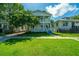 Charming two-story home with a well-manicured front yard and double porches on a sunny day at 1011 Ashley Ave, Charleston, SC 29403