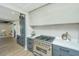 Modern kitchen featuring a professional-grade range and stylish gray cabinetry with light countertops at 1011 Ashley Ave, Charleston, SC 29403