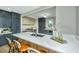 Modern kitchen featuring white countertops, a central island with seating, and a view of the dining and cooking areas at 1011 Ashley Ave, Charleston, SC 29403